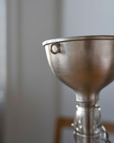 Up-close metal funnel by Azmaya in a bottle