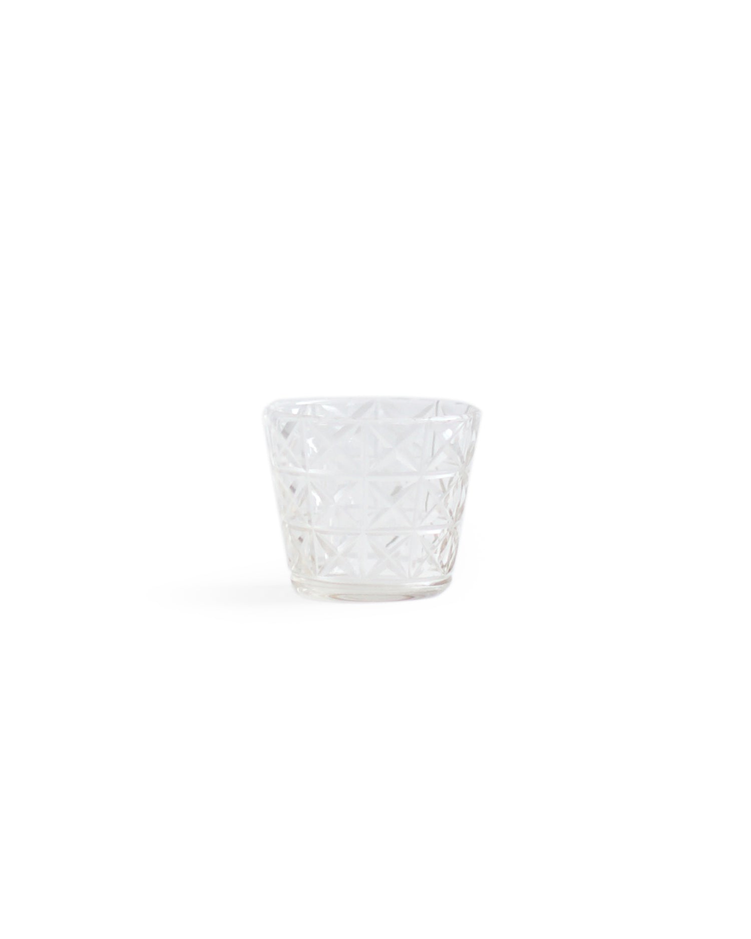 Silhouetted mini choko cut glass in crystal pattern against white background.