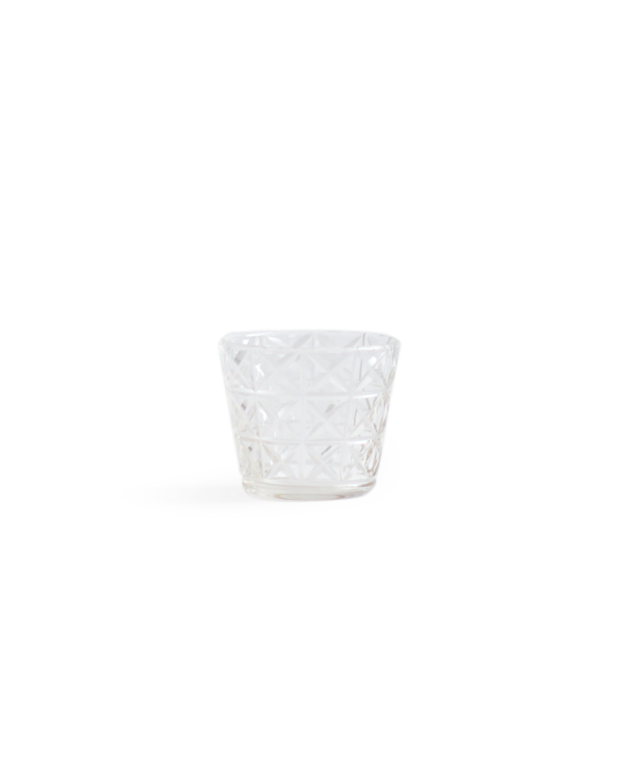 Silhouetted mini choko cut glass in crystal pattern against white background.