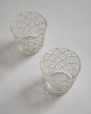 Two mini choko crystal cut glasses diagonally placed.