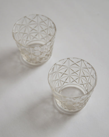 Two mini choko crystal cut glasses diagonally placed.