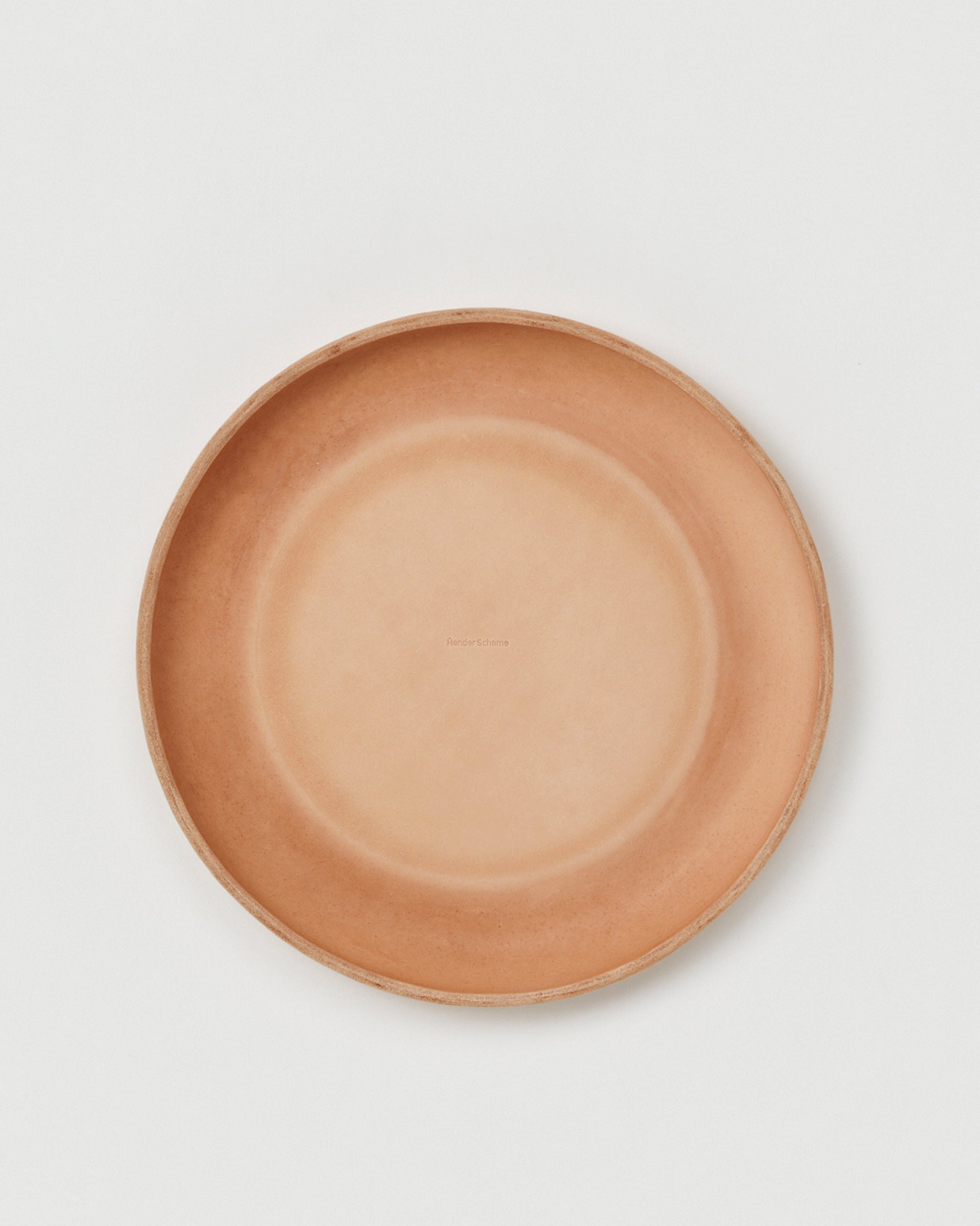 Top view of backside Flying Disc by Hender Scheme on a gray background
