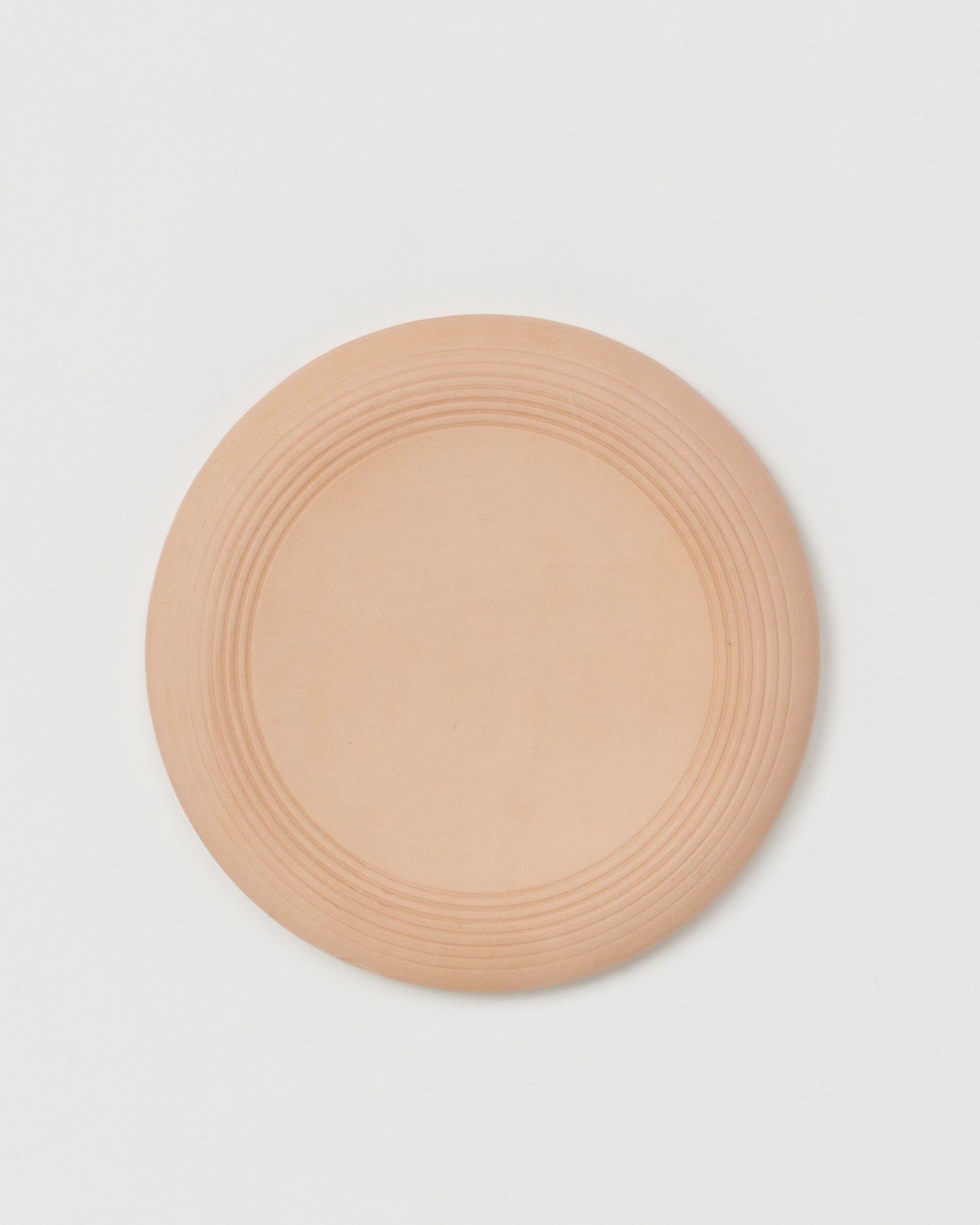 Top view of Flying Disc by Hender Scheme on a gray background