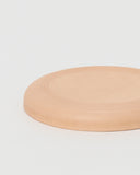 Flying Disc by Hender Scheme on a gray background