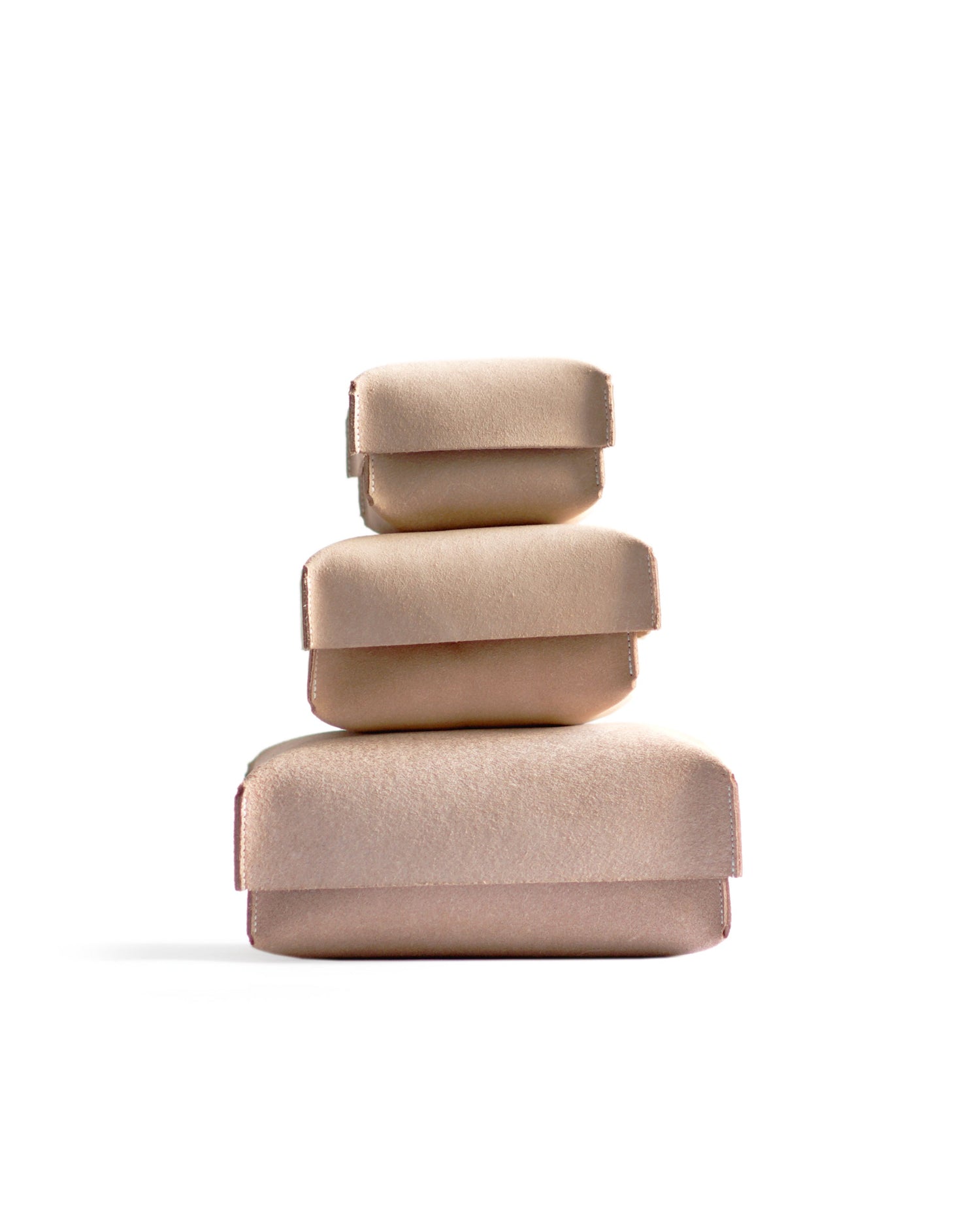 Silhouetted image of small, medium, large hender scheme two piece boxes are stacked on top of each other against white background.