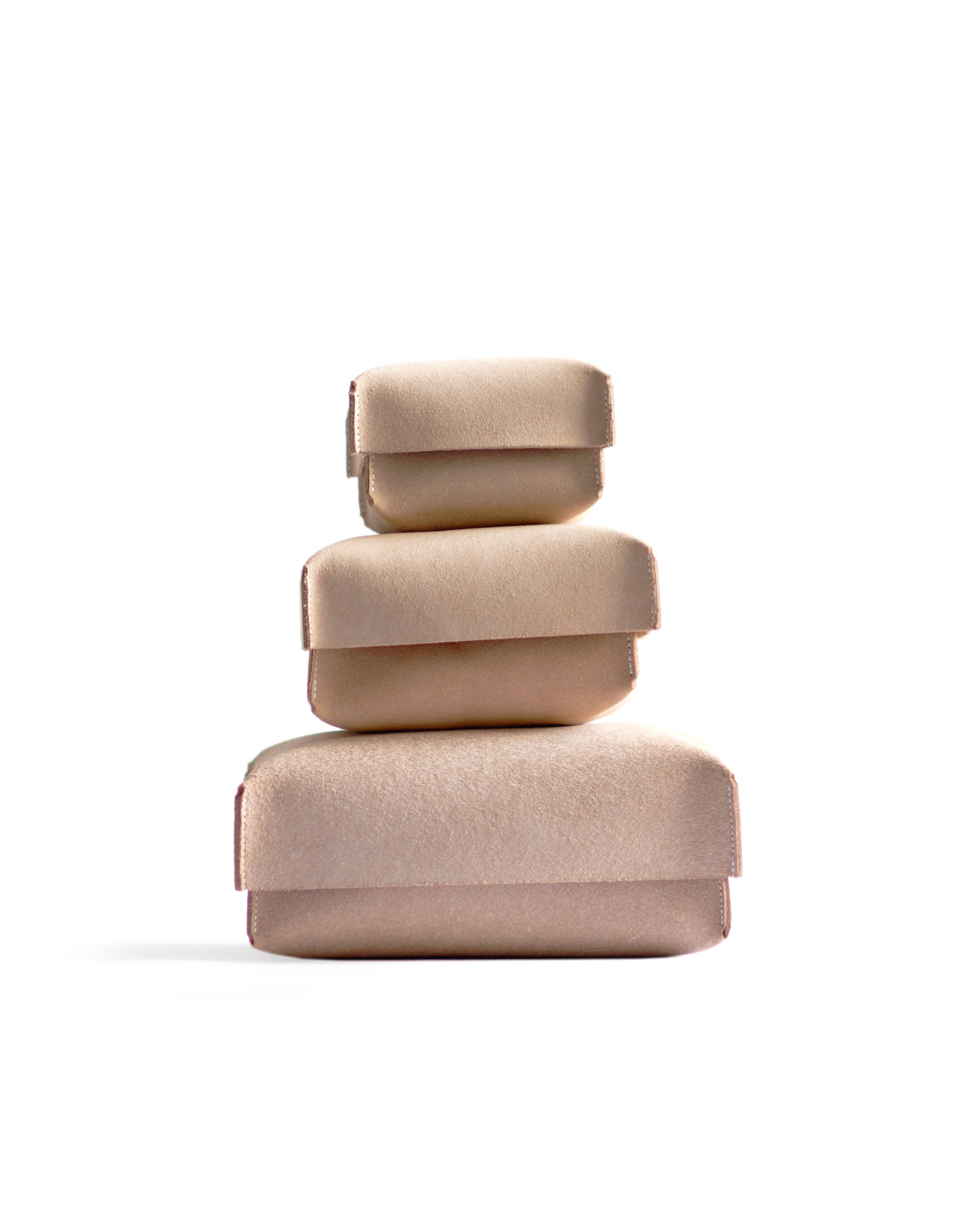 Silhouetted image of small, medium, large hender scheme two piece boxes are stacked on top of each other against white background.