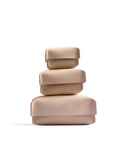 Silhouetted image of small, medium, large hender scheme two piece boxes are stacked on top of each other against white background.