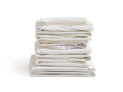 Stack of white folded sheets by Iwata on a white background