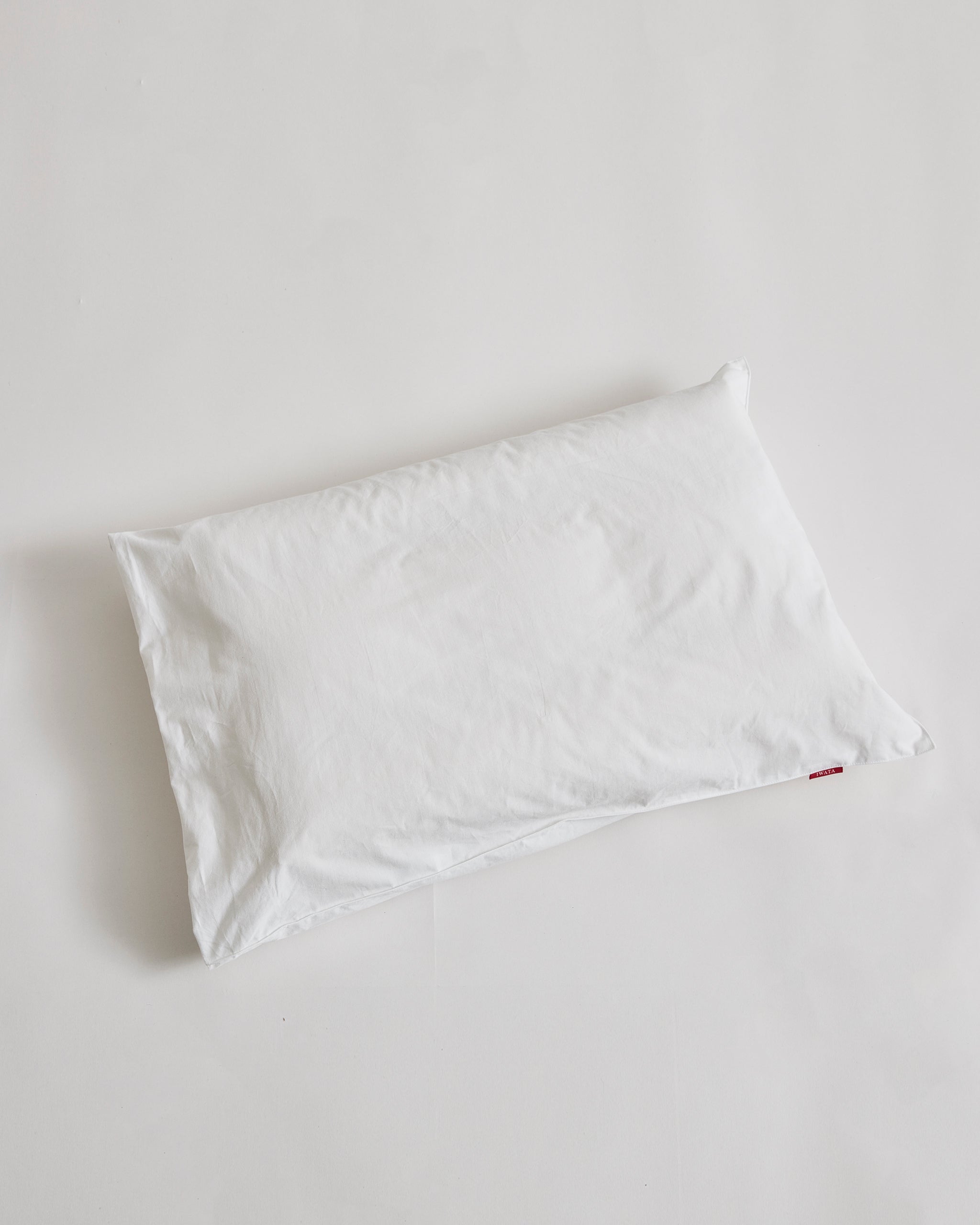 White pillowcase on a pillow by iwata on a light gray background