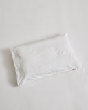 White pillowcase on a pillow by iwata on a light gray background
