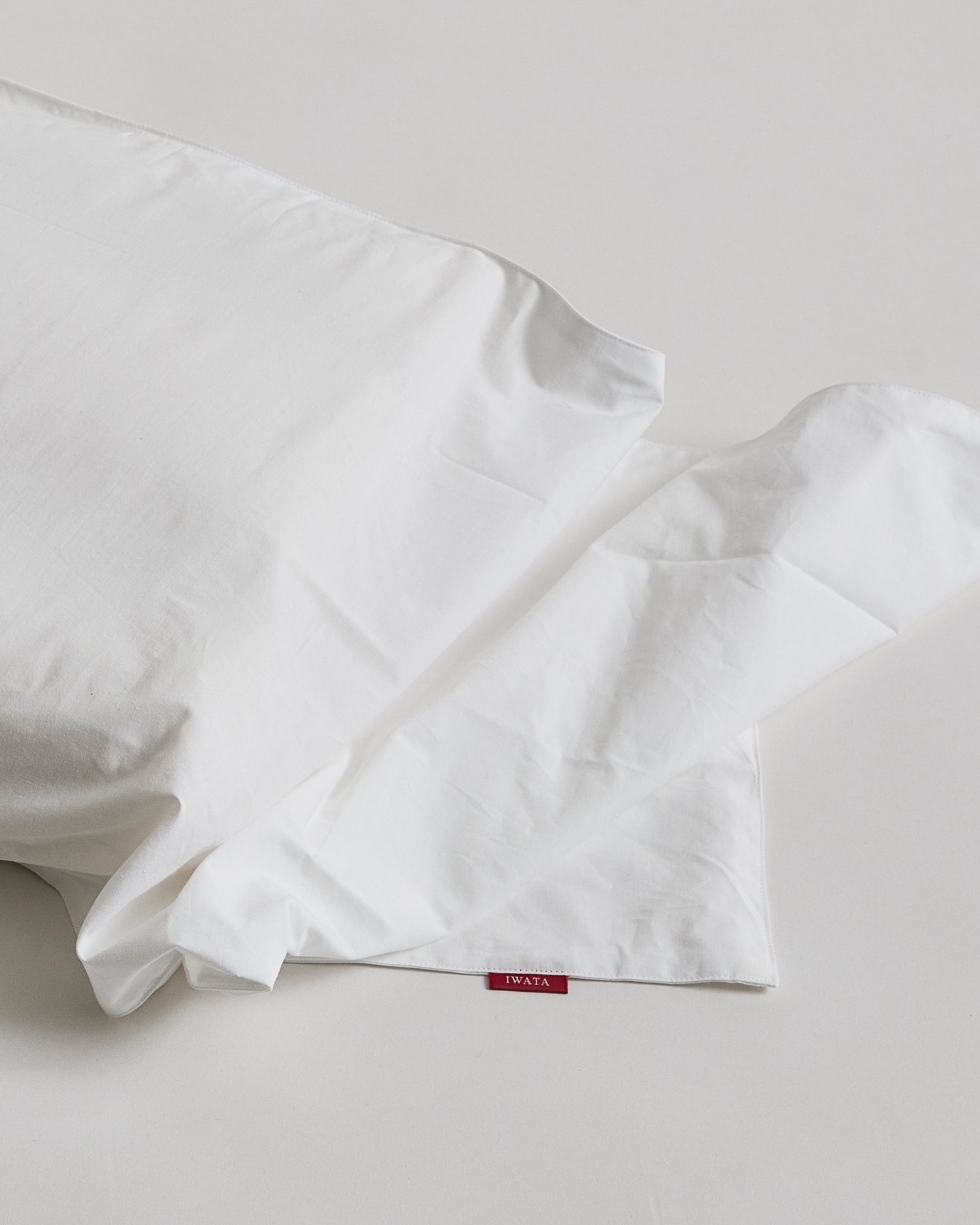 White pillowcase by Iwata on a light gray background 