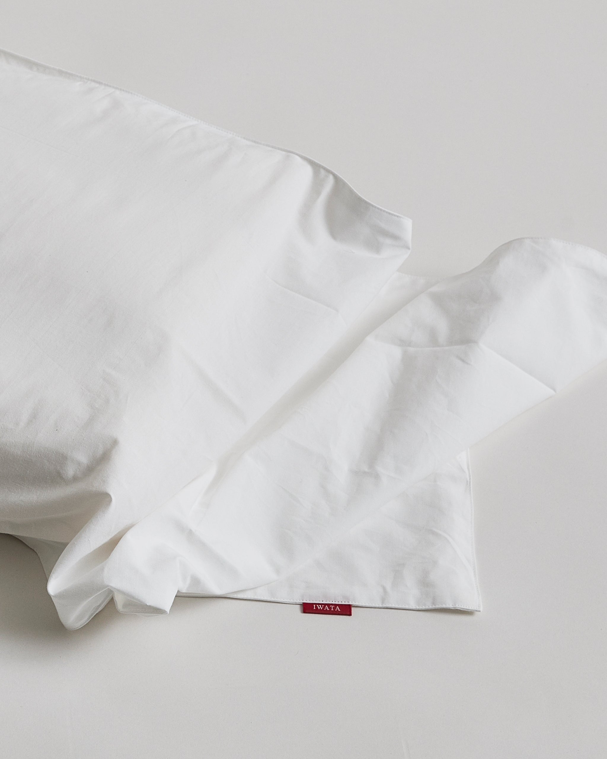 White pillowcase by Iwata on a light gray background 