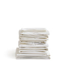Stack of white folded sheets by Iwata on a white background