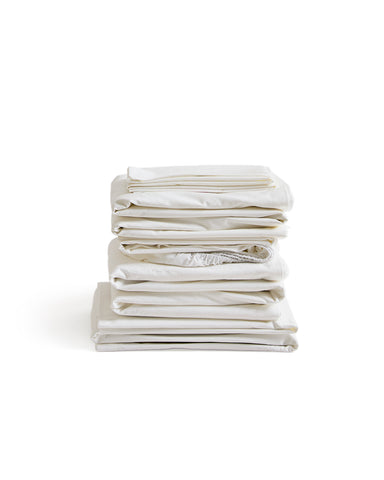 Stack of white folded sheets by Iwata on a white background