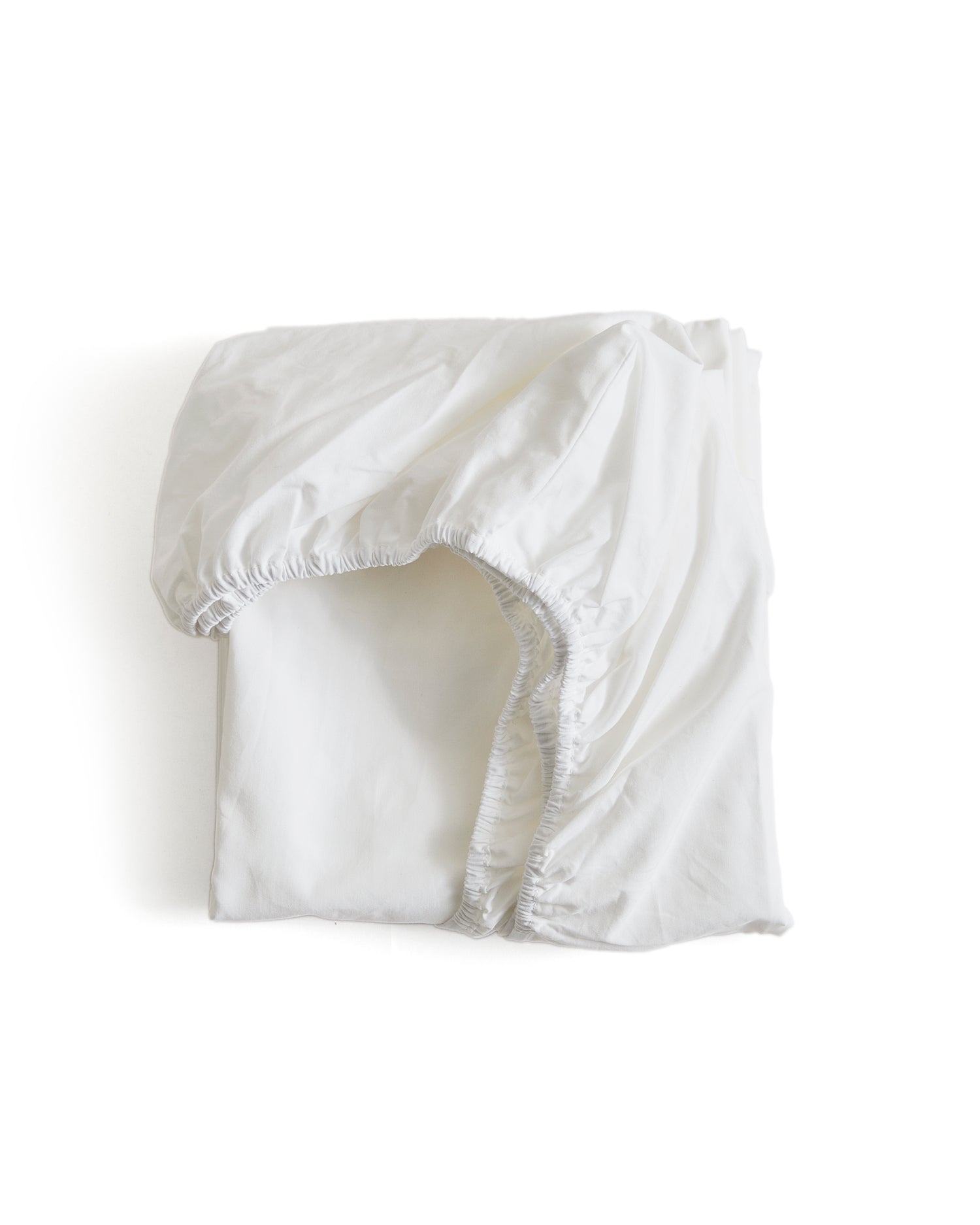 White folded fitted sheet by Iwata on a white background