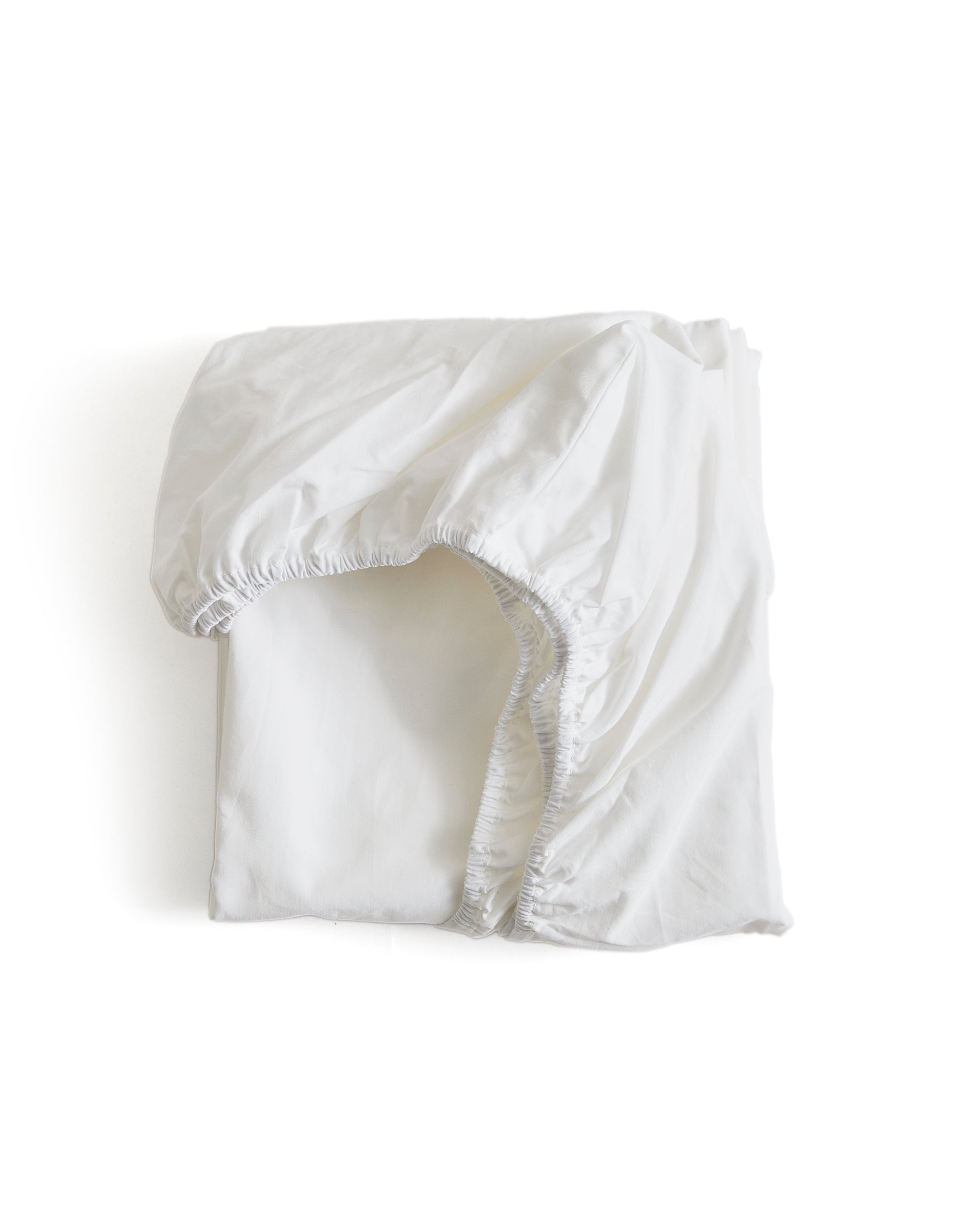 White folded fitted sheet by Iwata on a white background