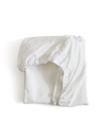 White folded fitted sheet by Iwata on a white background