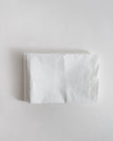White folded pillowcase by iwata on a light gray background