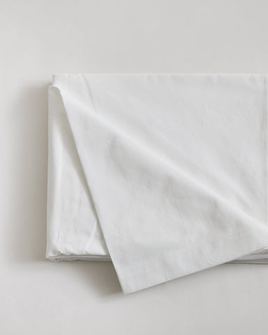 Folded white flat sheet by Iwata on a light gray background