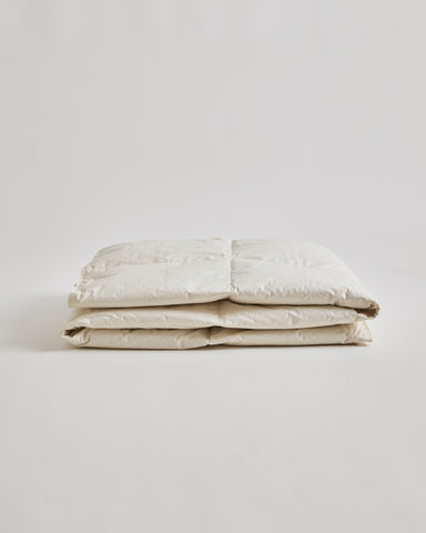 Folded Light Duvet by Iwata on a gray background