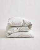 Folded white duvet cover on a duvet by Iwata on a gray background
