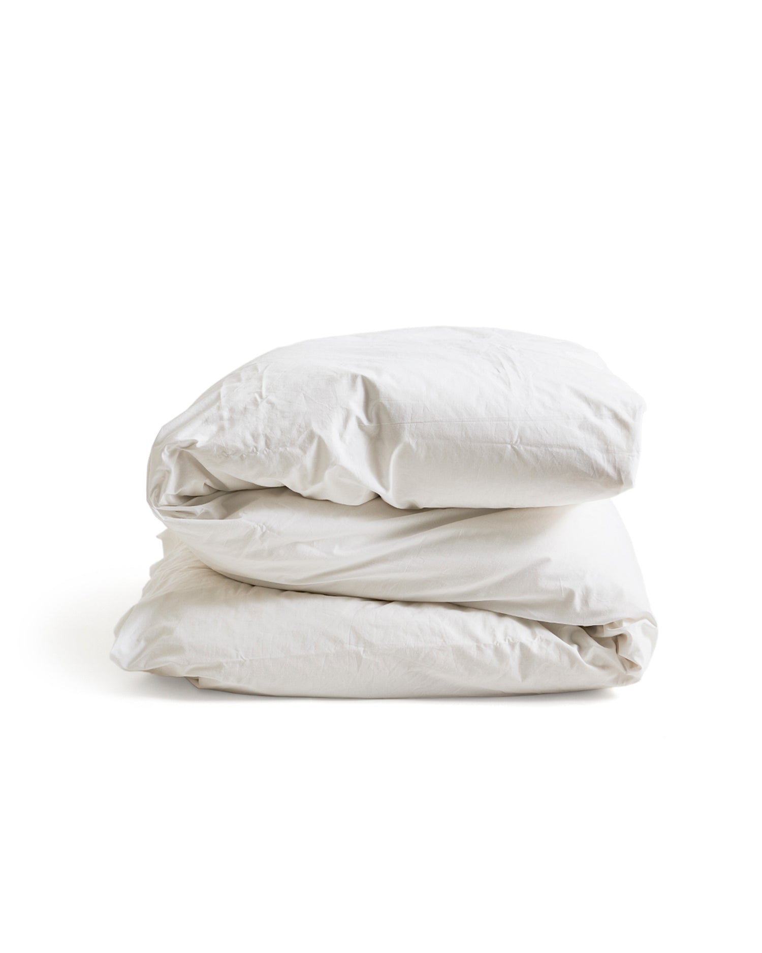 Folded white duvet cover on a duvet by Iwata on a white background