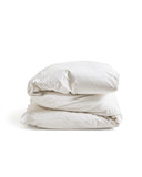 Folded white duvet cover on a duvet by Iwata on a white background
