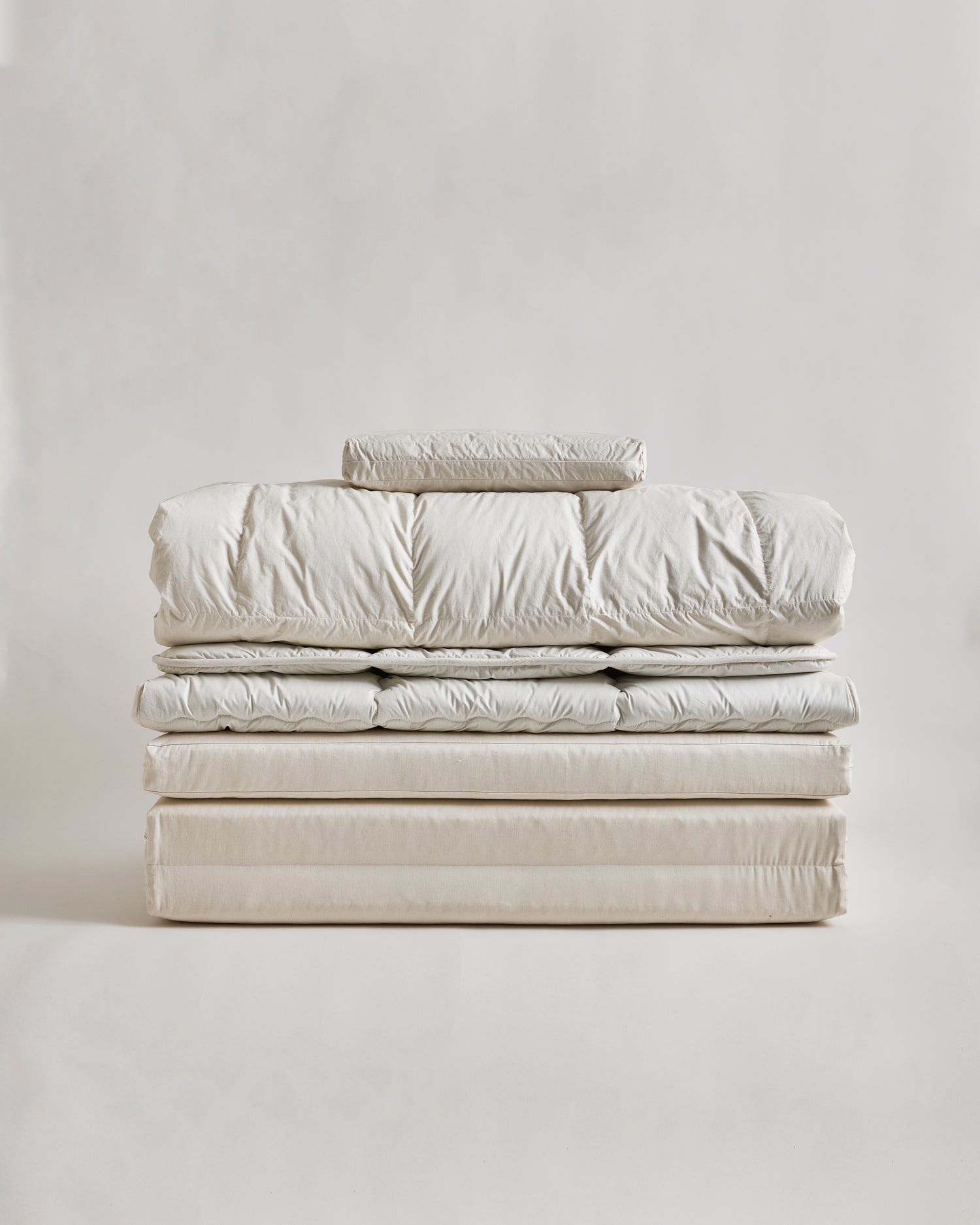 Stack of nezen bedding by iwata on a light gray background