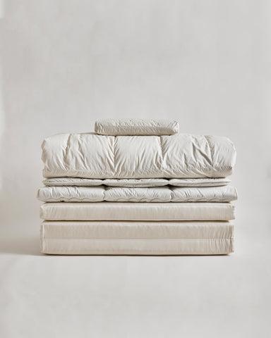 Stack of nezen bedding by iwata on a light gray background
