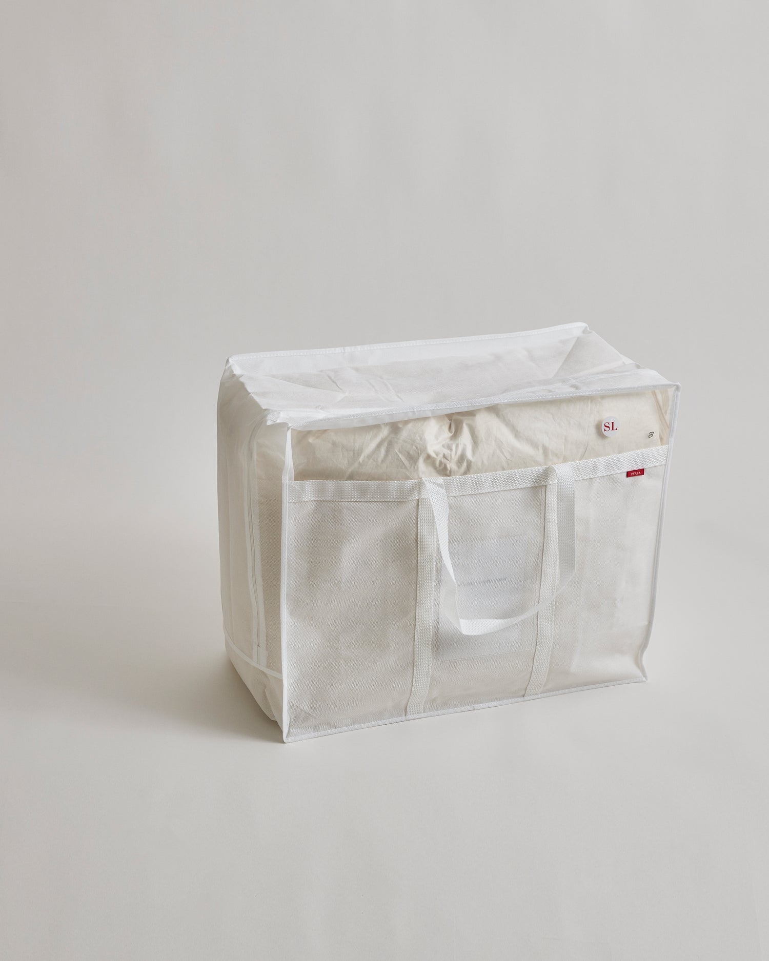 Duvet storage box with handles by Iwata on a light gray background