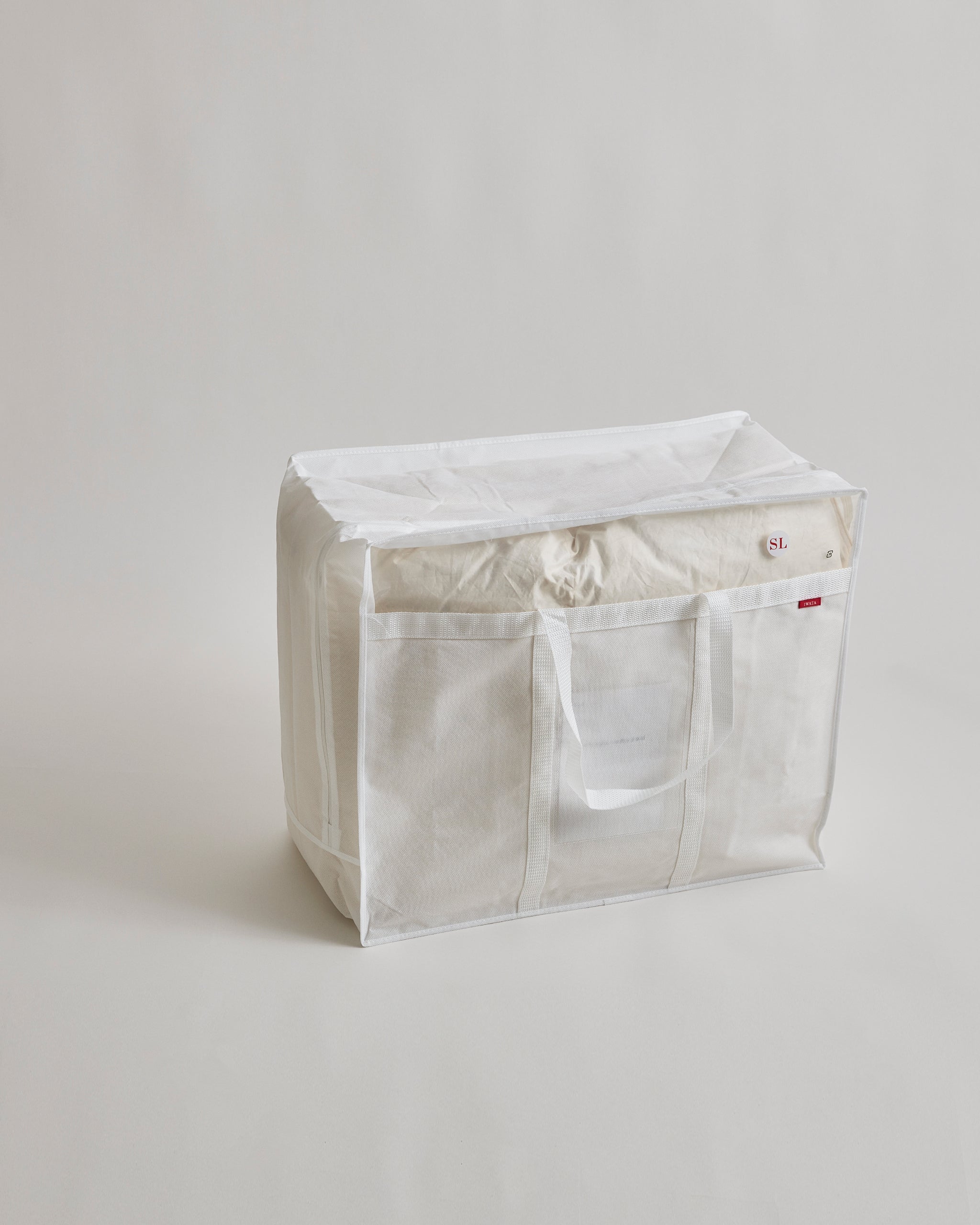 Duvet storage box with handles by Iwata on a light gray background