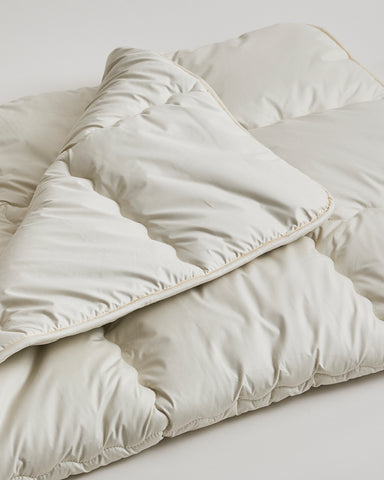 Up-Close of Camel Heavy Mattress Pad by Iwata on a gray background