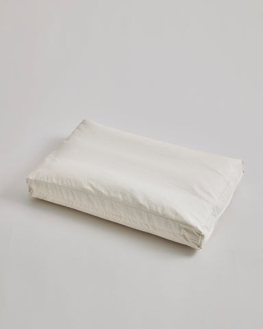 CAmel hair pillow by Iwata on a light gray background