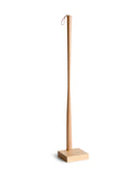 Wooden shoe horn with square base by Nalata Nalata and Kime on a white background