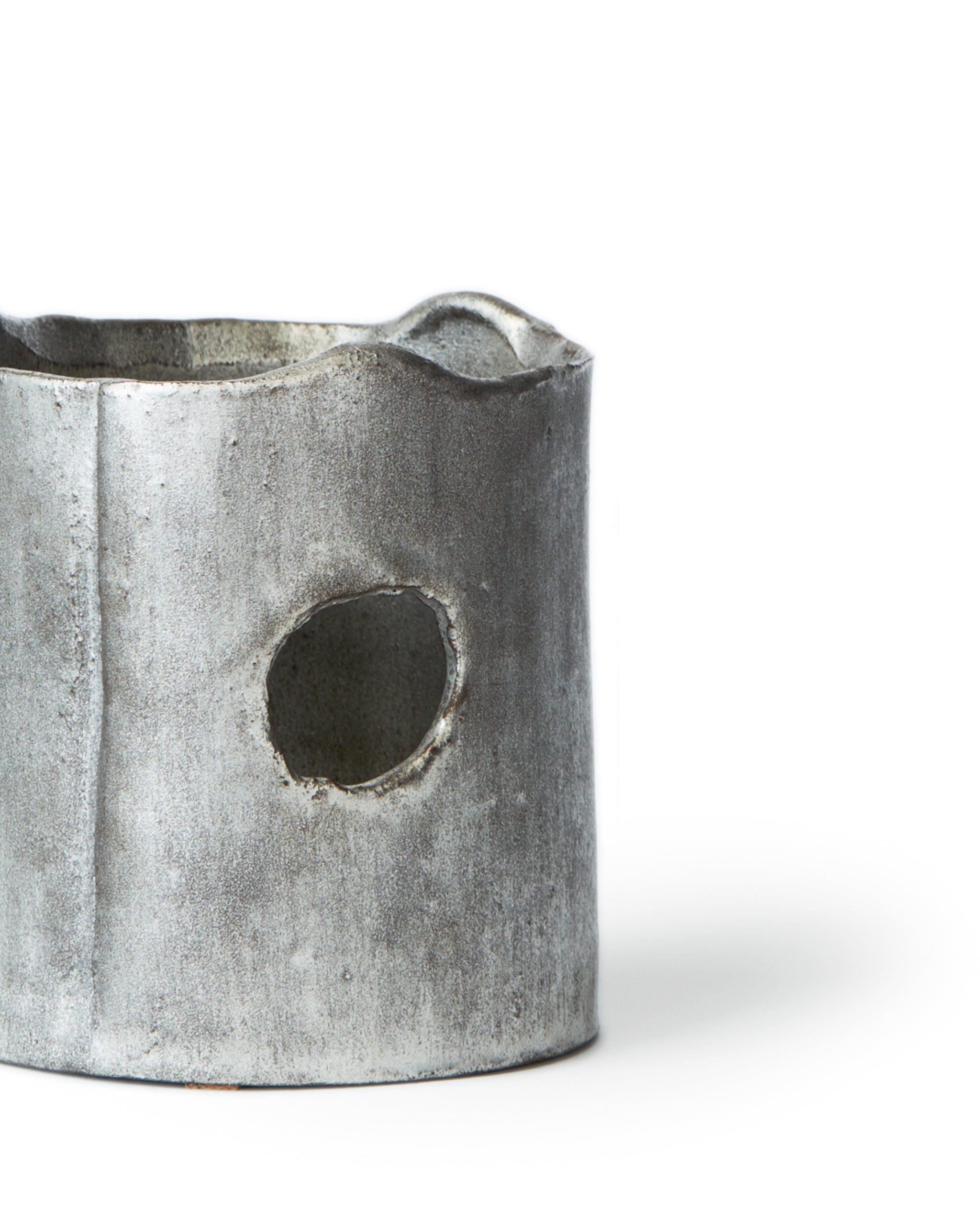 Cropped image of ceramic teapot warmer with sterling silver overglaze by Masanobu Ando against white background.