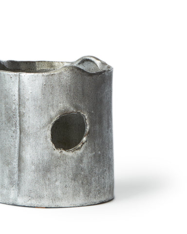 Cropped image of ceramic teapot warmer with sterling silver overglaze by Masanobu Ando against white background.