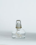 Front view of oil lamp that pairs with the ceramic teapot warmer with sterling silver overglaze by Masanobu Ando against white-gray background.