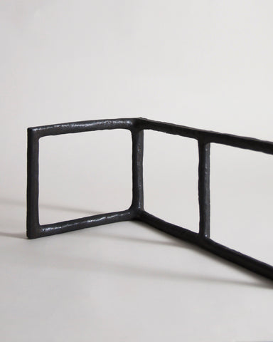 Up-close of Black Rust Glaze Boundary Sculpture by Masanobu Ando on a gray background