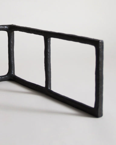 Up-close of Black Rust Glaze Boundary Sculpture by Masanobu Ando on a gray background
