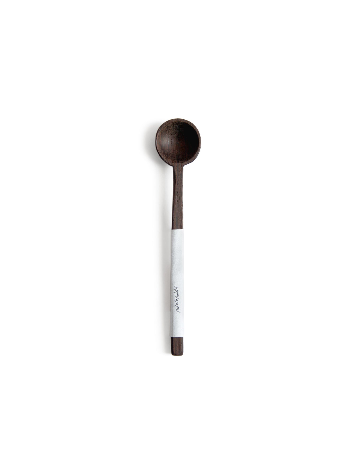 Silhouetted image of hand carved tagaya wood spoon with label by Nalata Nalata against white background.