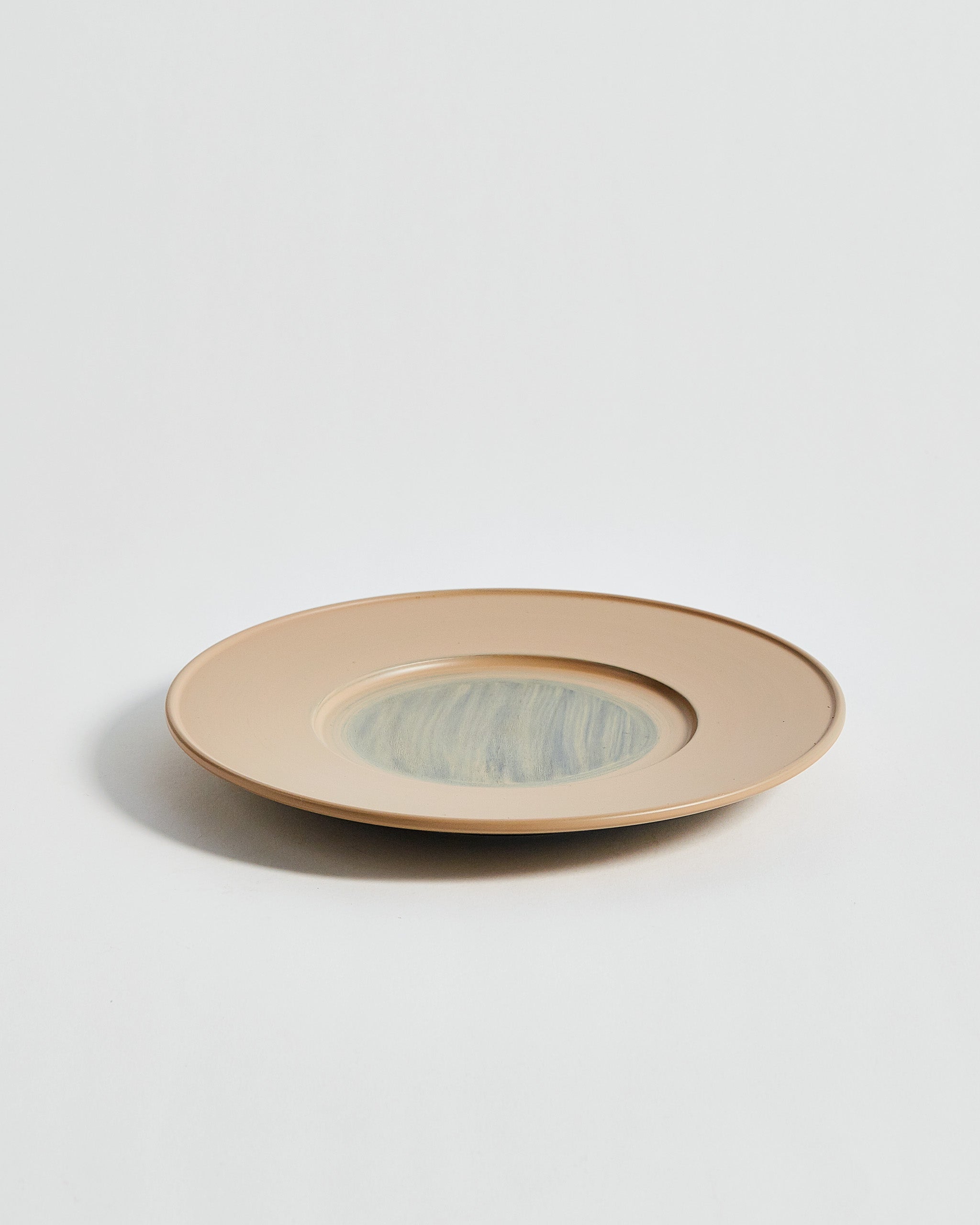 Angled view of large White Urushi Plate by Ryuji Mitani against white-gray background. 