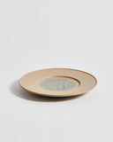 Angled view of large White Urushi Plate by Ryuji Mitani against white-gray background. 
