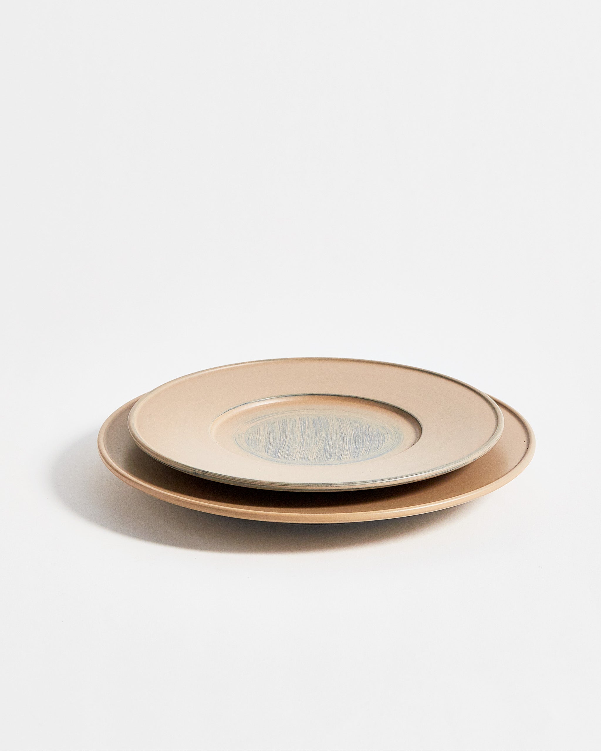 Angled view of stacked small and large White Urushi Plate by Ryuji Mitani against white-gray background. 