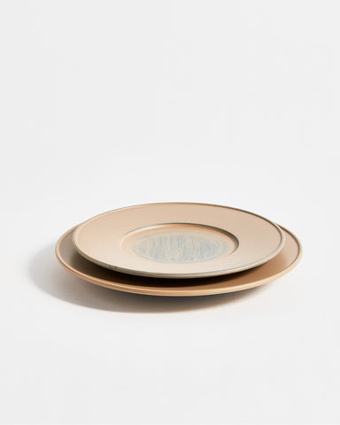 Angled view of stacked small and large White Urushi Plate by Ryuji Mitani against white-gray background. 