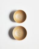 Top view of White Urushi Baby Bowl Set, vertically side-by-side, by Ryuji Mitani against white-gray background.
