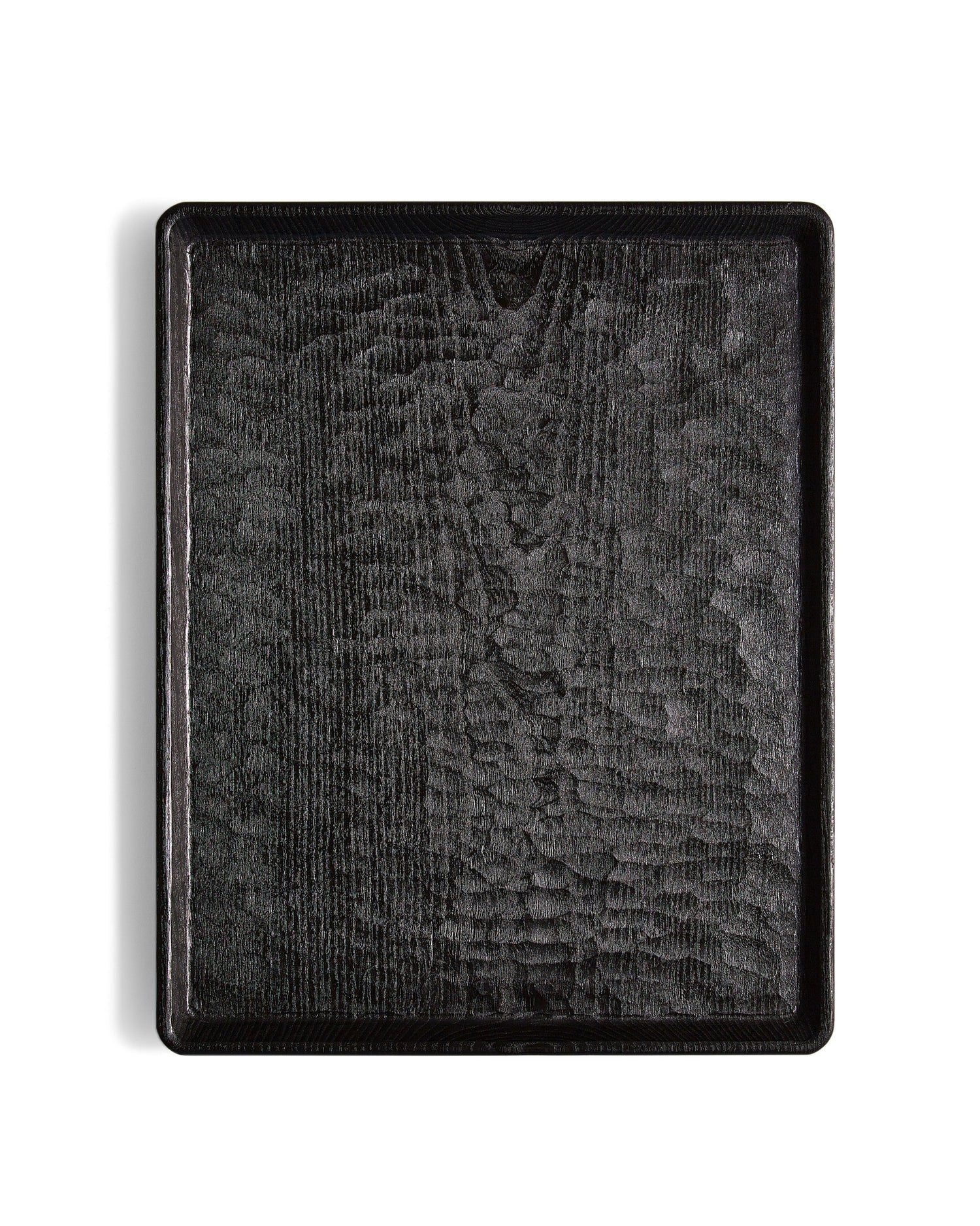 Silhouetted image of Carved Noir Wood Tray with Enju Wood by Ryuji Mitani against white background.