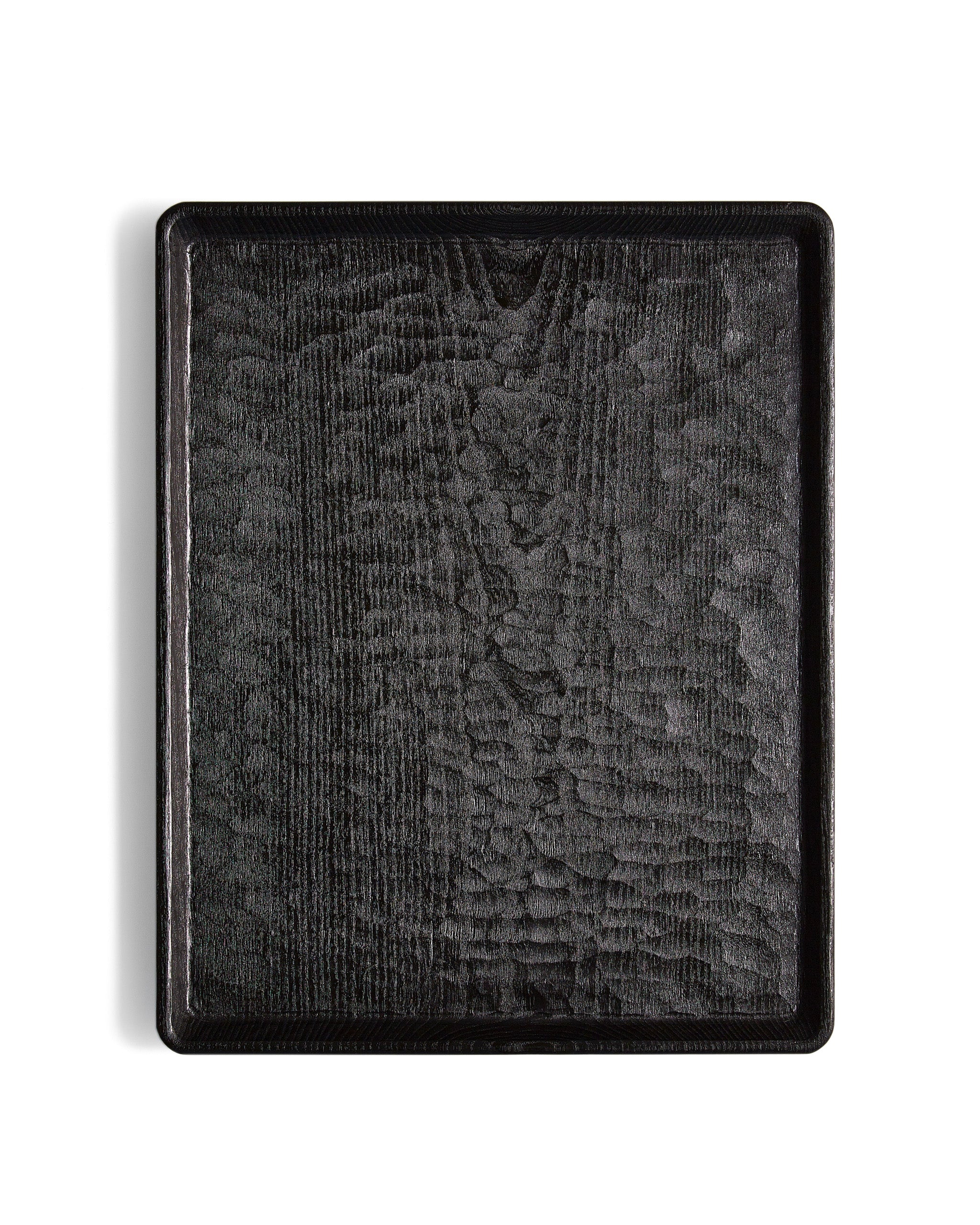 Silhouetted image of Carved Noir Wood Tray with Enju Wood by Ryuji Mitani against white background.