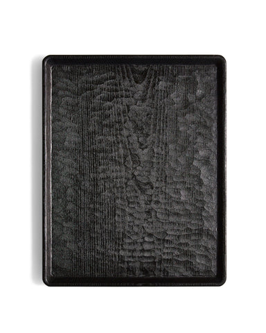 Silhouetted image of Carved Noir Wood Tray with Enju Wood by Ryuji Mitani against white background.