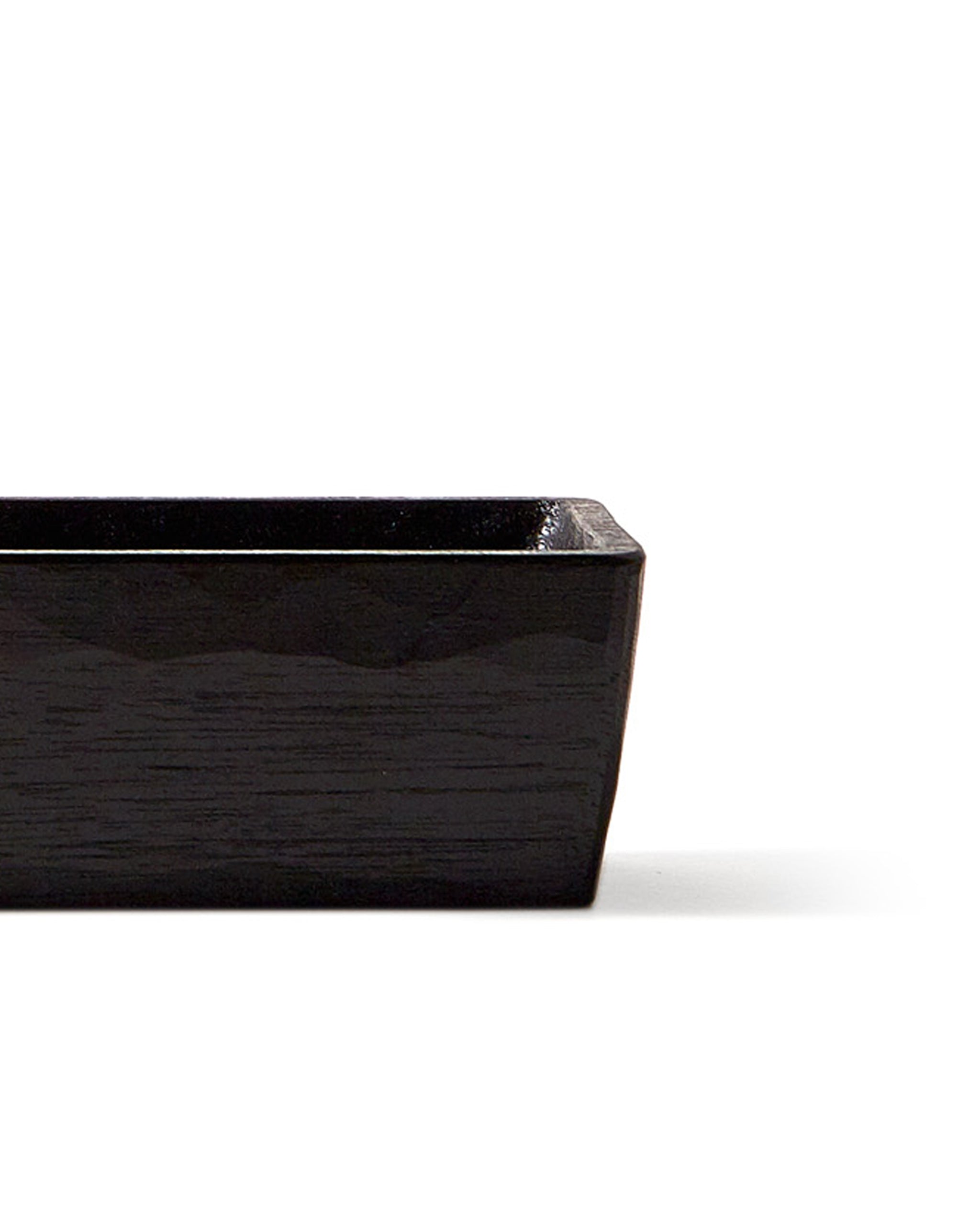 Silhouetted image of detail of Chopsticks Holder by Ryuji Mitani against white background.