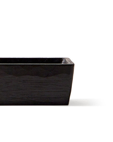 Silhouetted image of detail of Chopsticks Holder by Ryuji Mitani against white background.